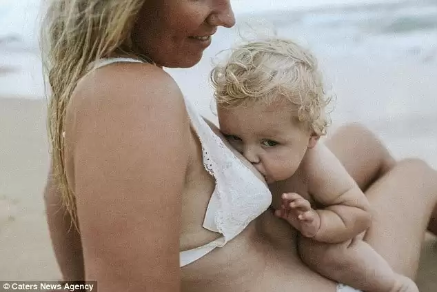 Stunning photos capture the deep bond between mother and child through breastfeeding moments on the beach, celebrating resilience and postpartum love.