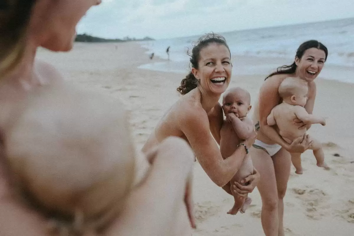 Stunning photos capture the deep bond between mother and child through breastfeeding moments on the beach, celebrating resilience and postpartum love.